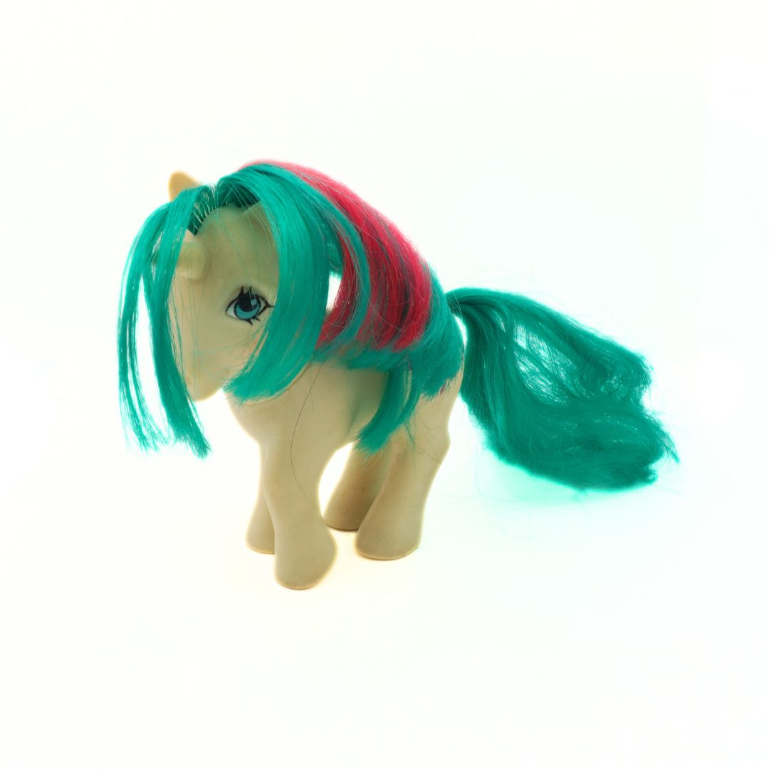 Toy horse with teal and pink hair on a white background