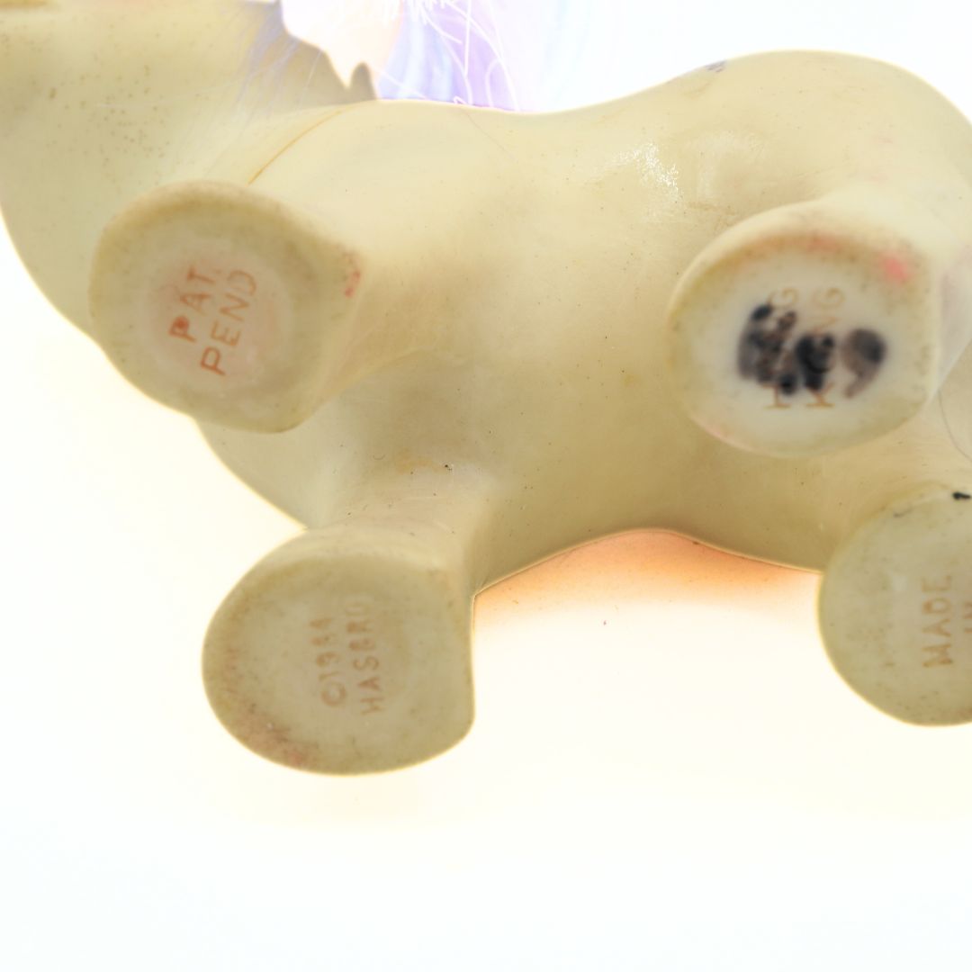 Close-up of a white hours figure with visible branding on a white background