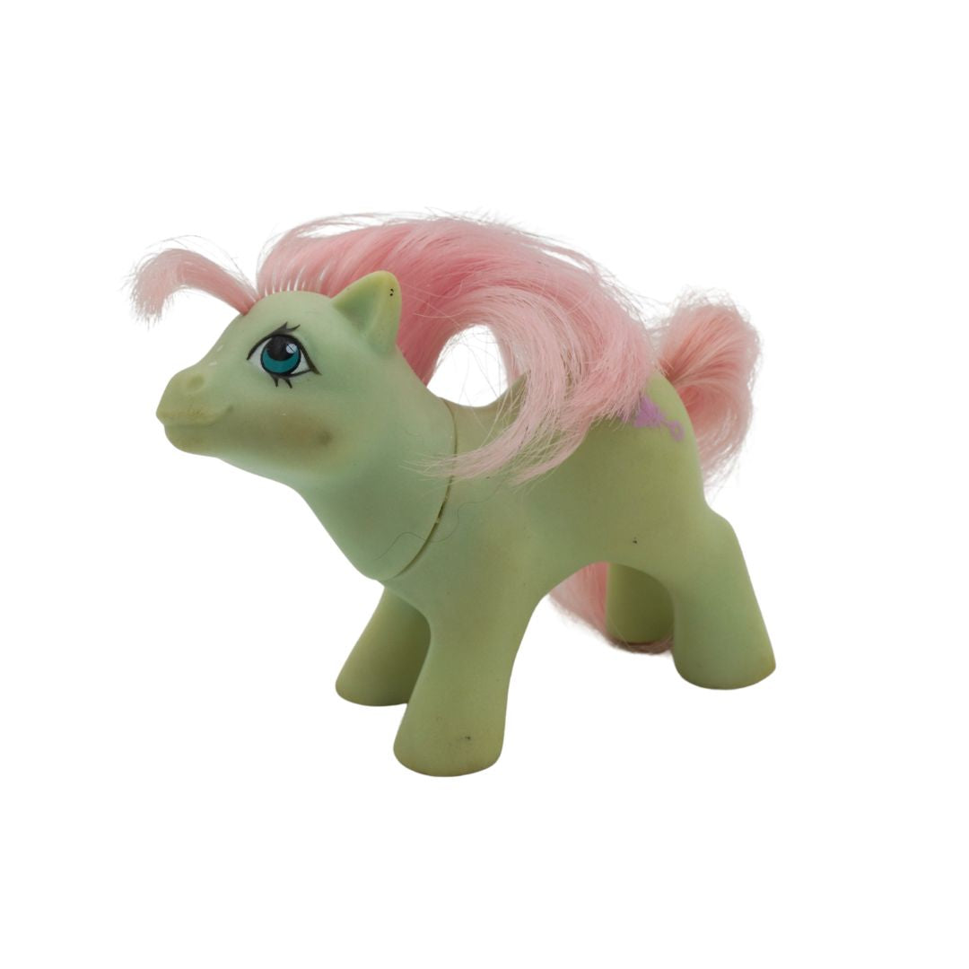 1985 G1 Baby Cuddles My Little Pony with a green body, blue eyes and a pink hair