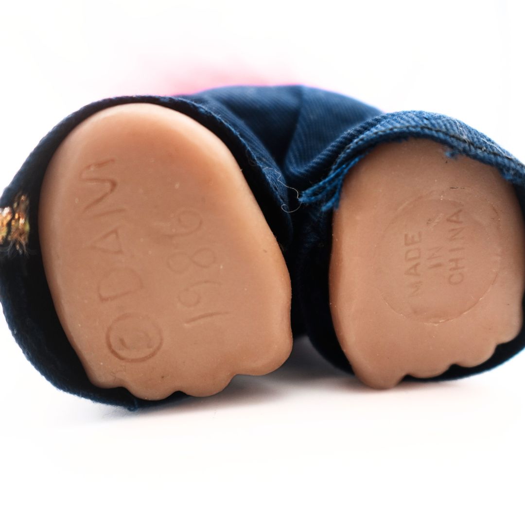 Underside of the feet of a 1986 Policeman Troll Doll with Dam branding and a made in China stamp