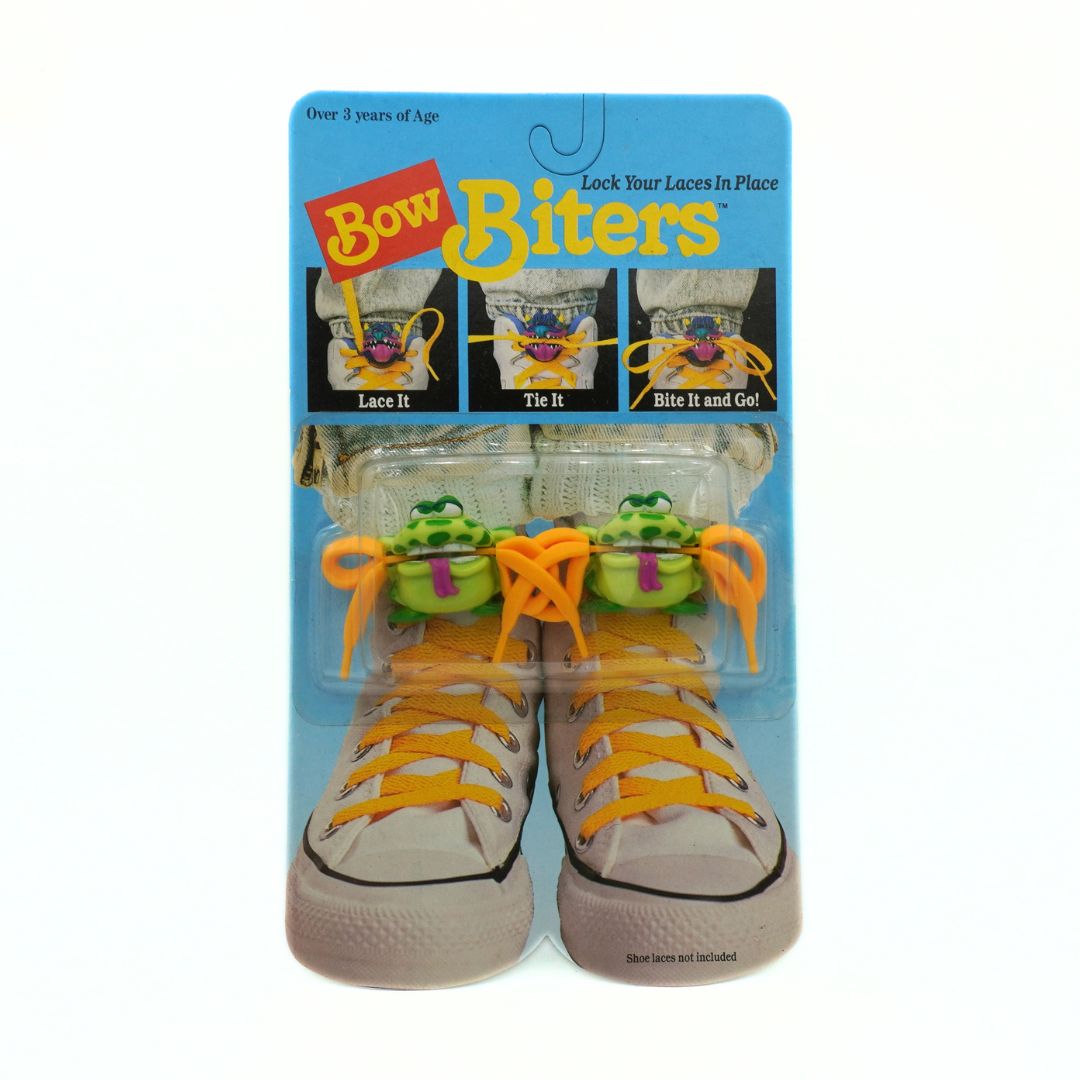 Bow Biters shoe lace holder packaging with shoes and laces on a white background