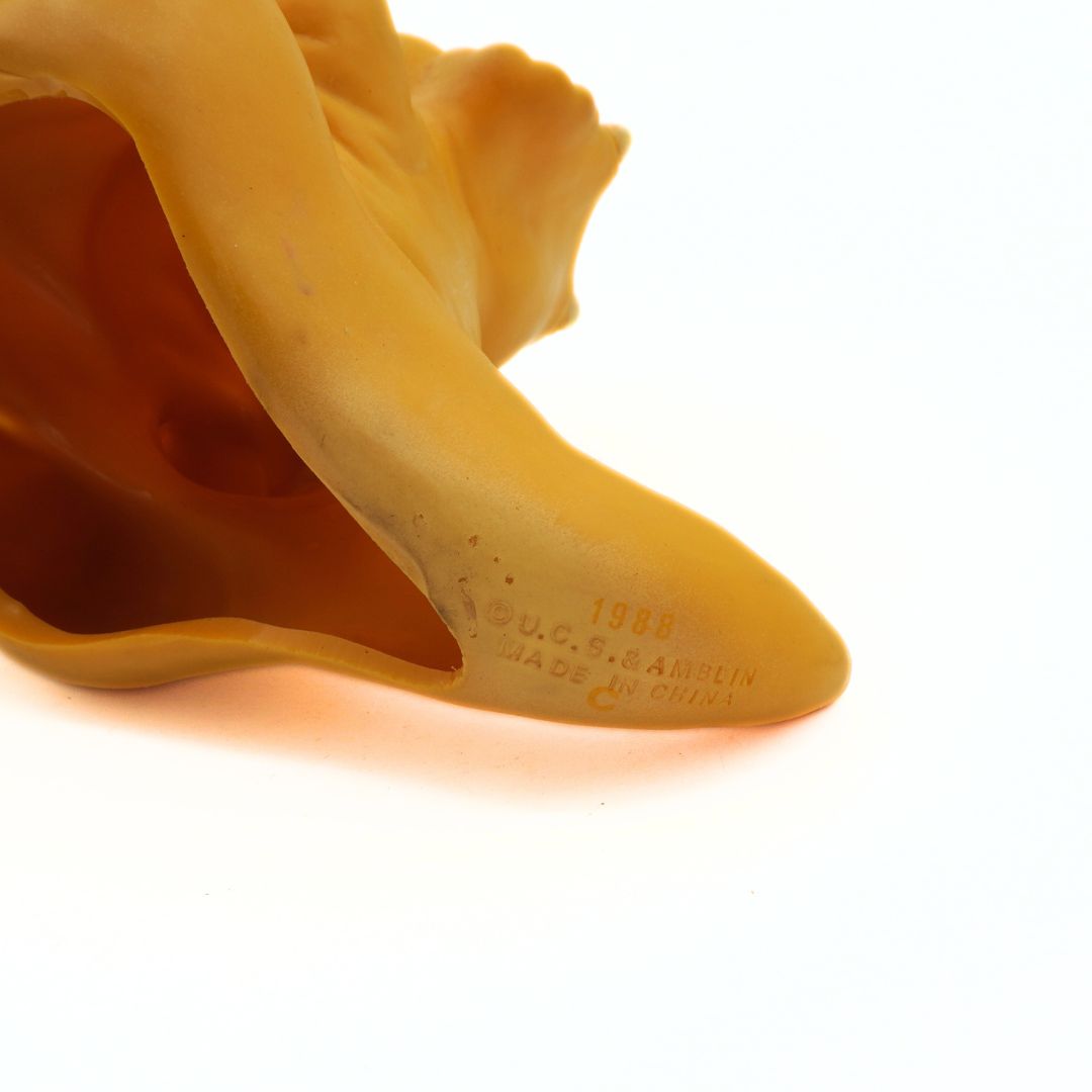 Close-up of a yellow rubber boot sole with 'U.C.S. Amblin' branding on a white background