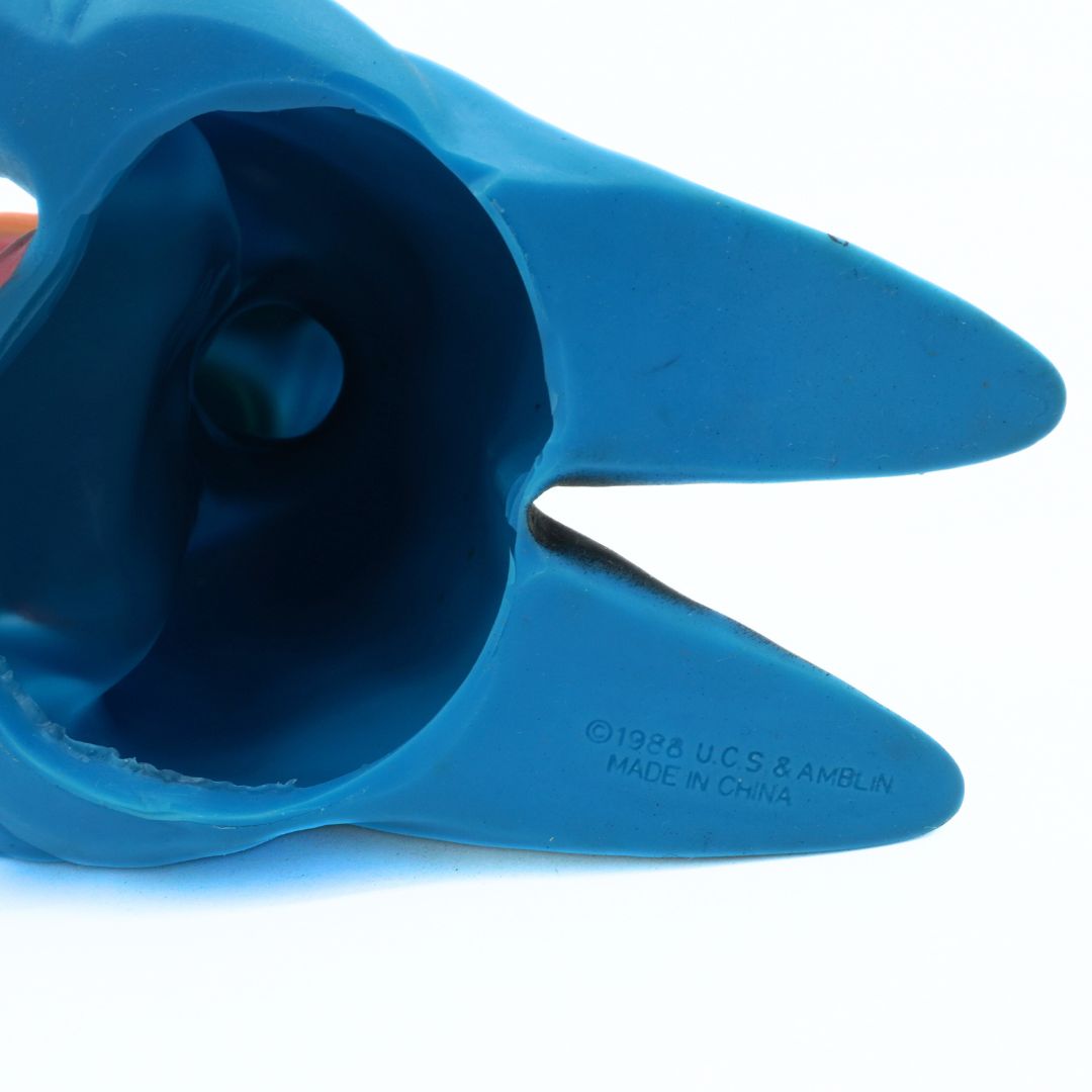 Blue plastic toy with a pointed end on a white background