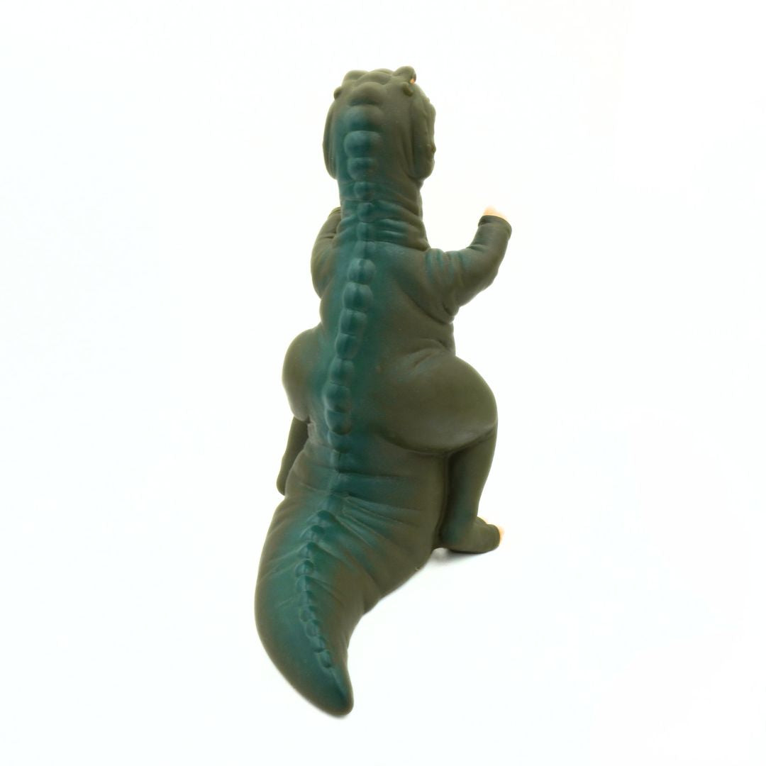 Green dinosaur toy on a white background