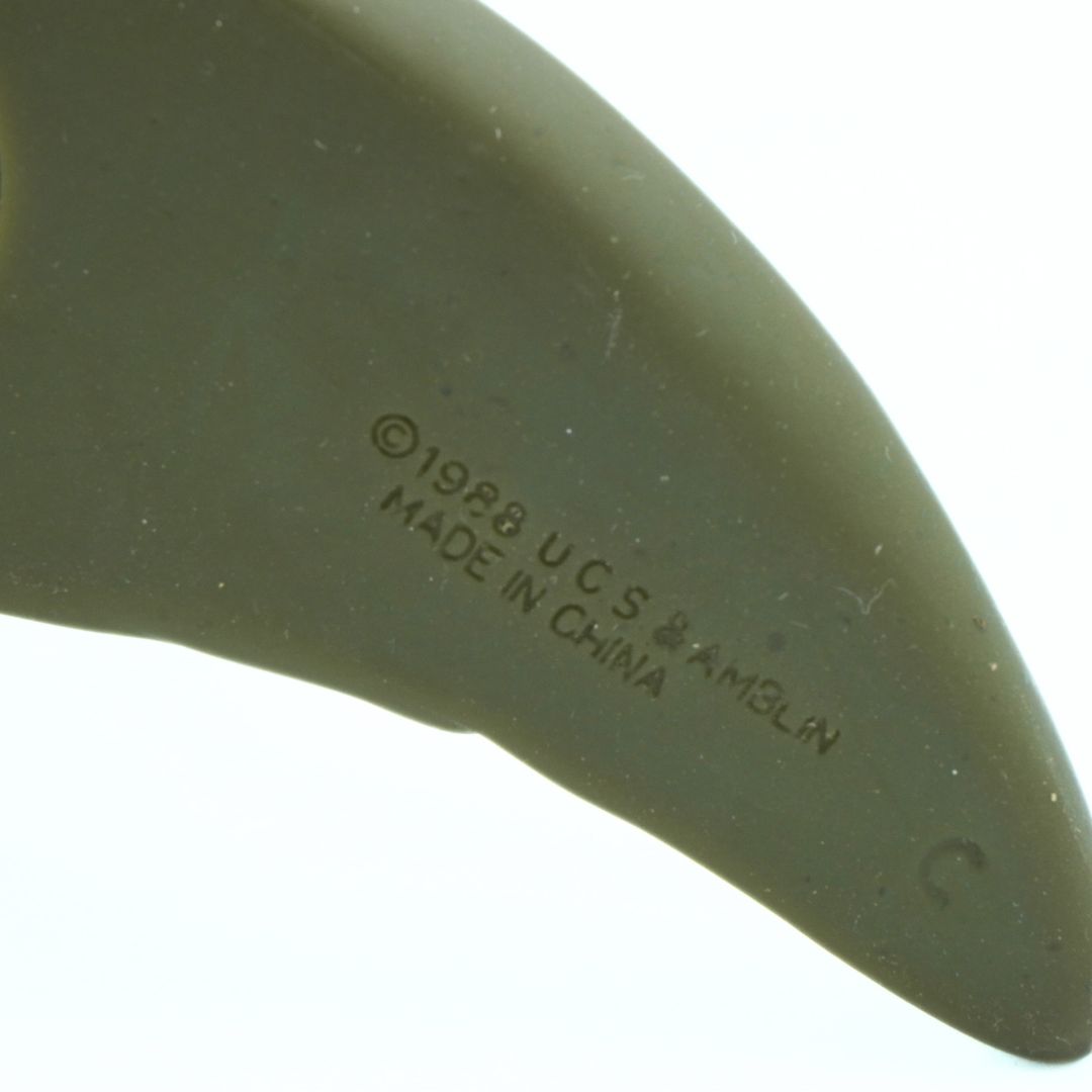 Close-up of a green object with 'Made in China' text on a white background