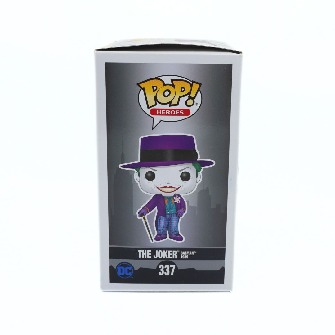 Funko Pop! Heroes The Joker vinyl figure number 337, shown in its original white packaging box with a dark gray insert featuring the character illustration.