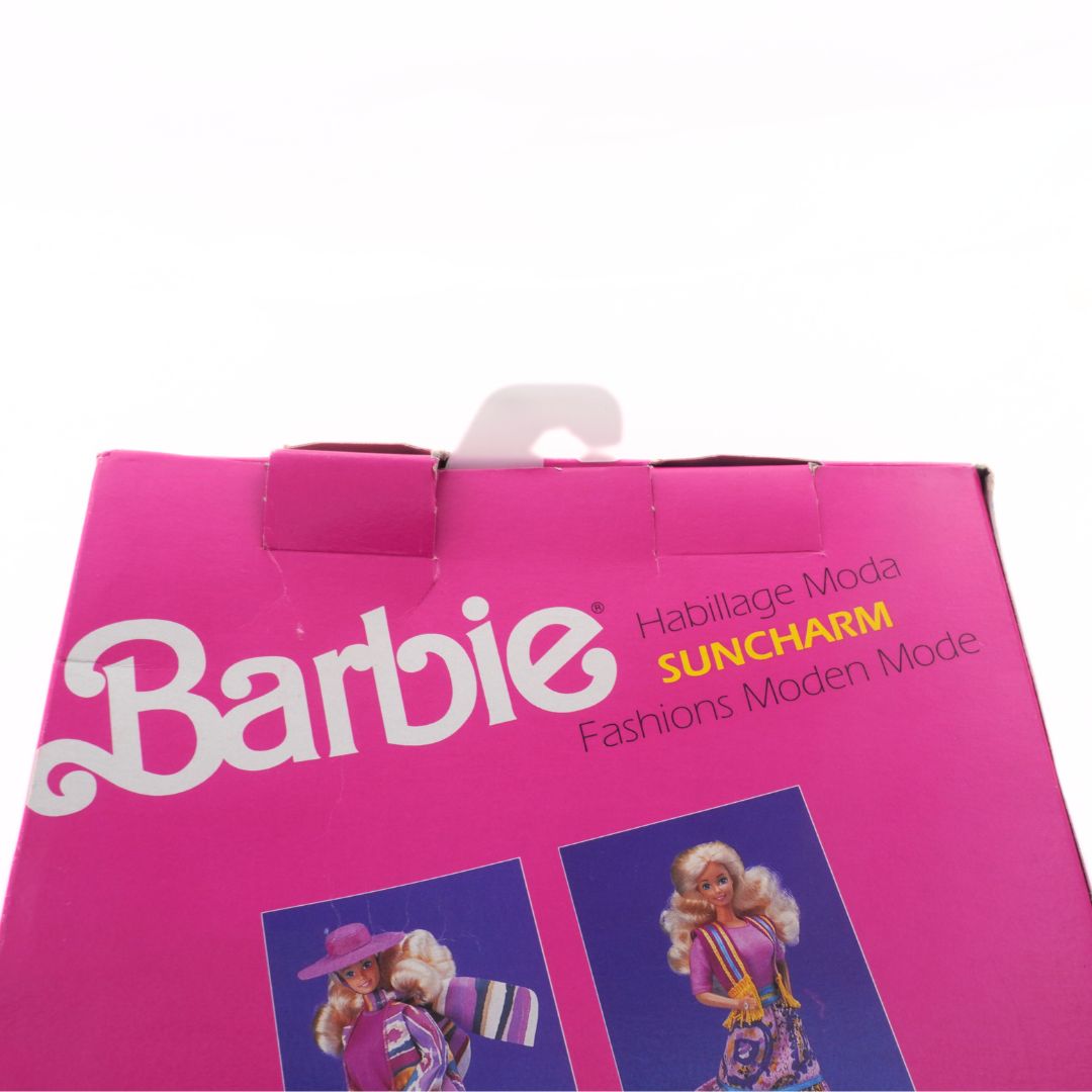 Barbie packaging with pink background and images of dolls on a white background