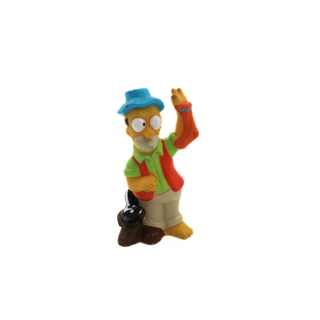 Homer Simpson figure with a skunk in his boot, holding a stinky sock