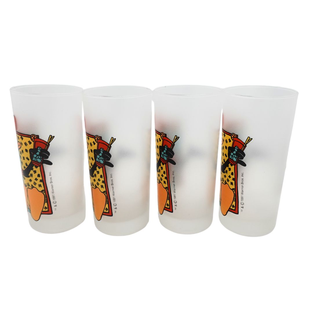 Side on photo of a set of four 1991 Daffy Duck glasses showing the Warner Bros copyright