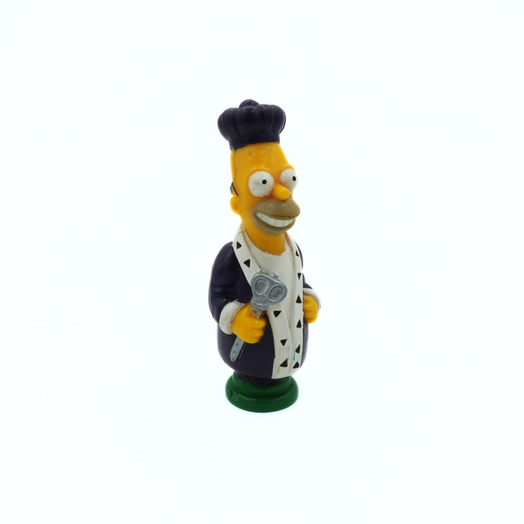 Figurine of a character from 'The Simpsons' wearing a kings hat and coat on a white background