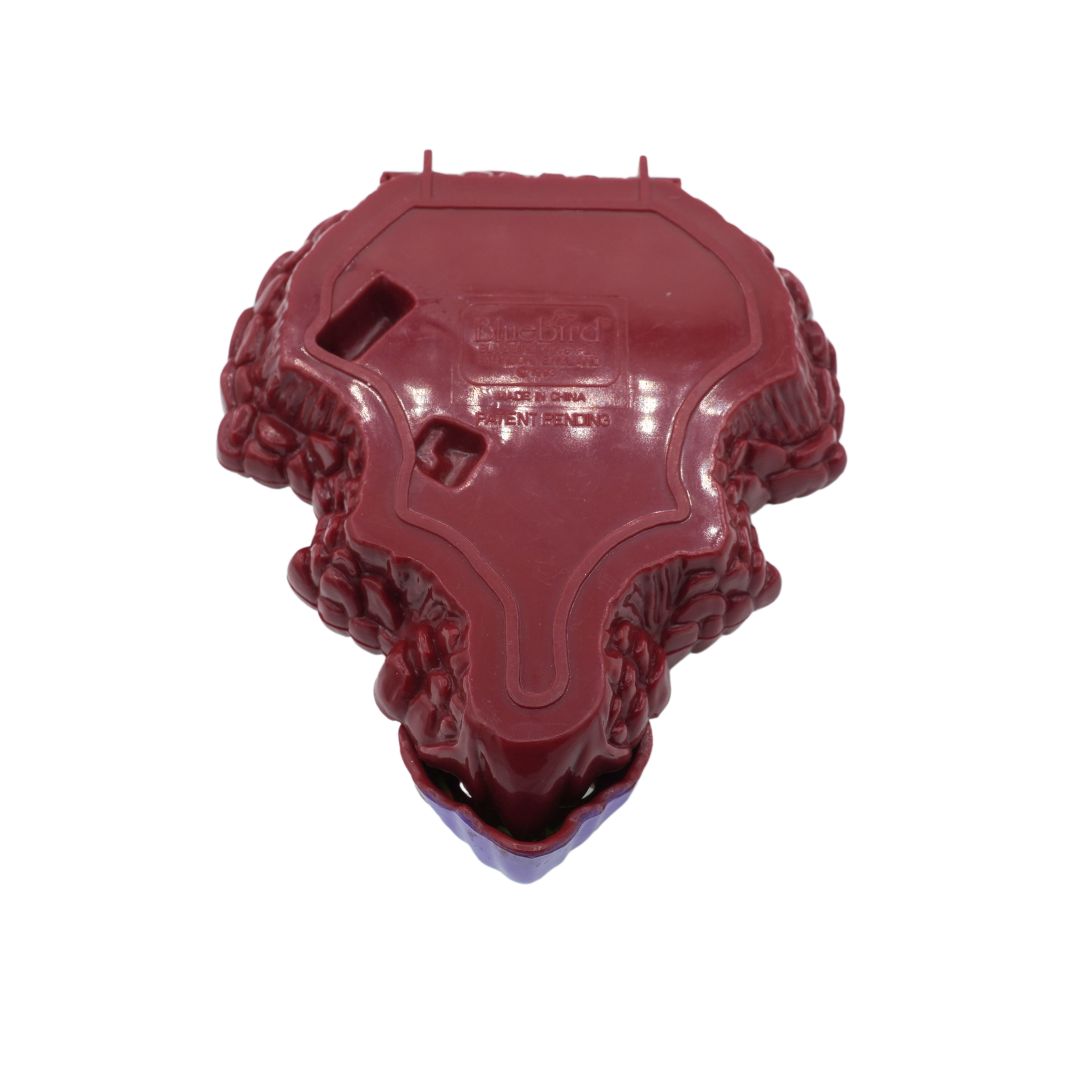 A red, green and purple Triceratops Mighty Max playset, photographed against a white background