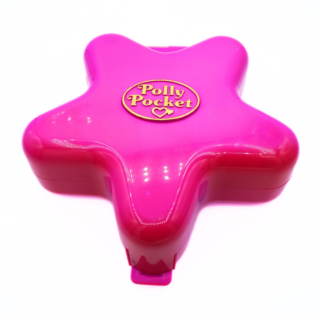 Pink star-shaped Polly Pocket toy on a white background
