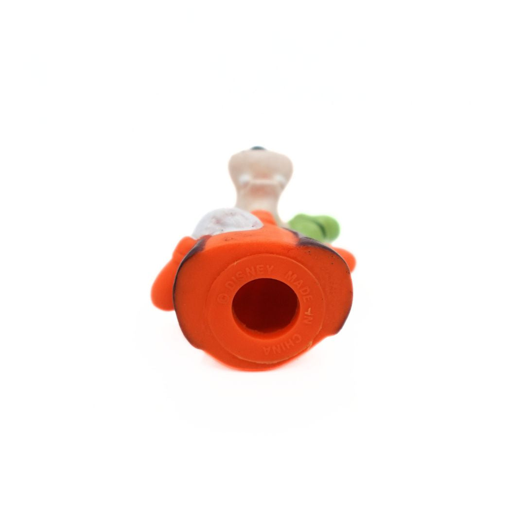 Photo of the underside of a 1994 Goofy figurine released as a Happy Meal toy wearing an orange and brown shirt with a green hat