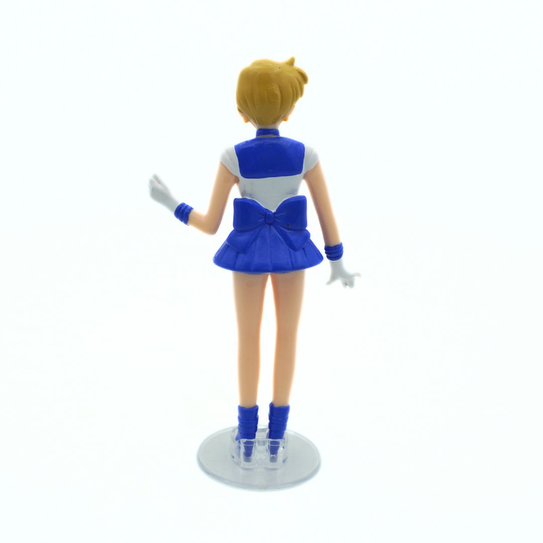 Action figure in a blue outfit with a white background