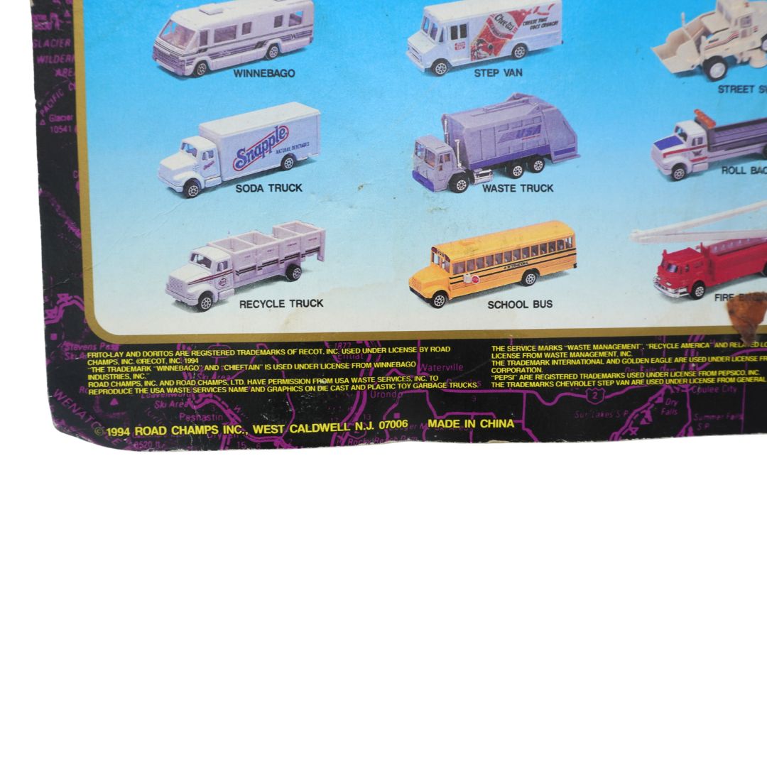 Collection of toy vehicles on a display card with labels.
