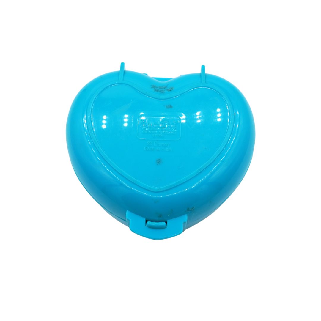 Blue heart shaped Polly Pocket from 1995 seen from the underside.