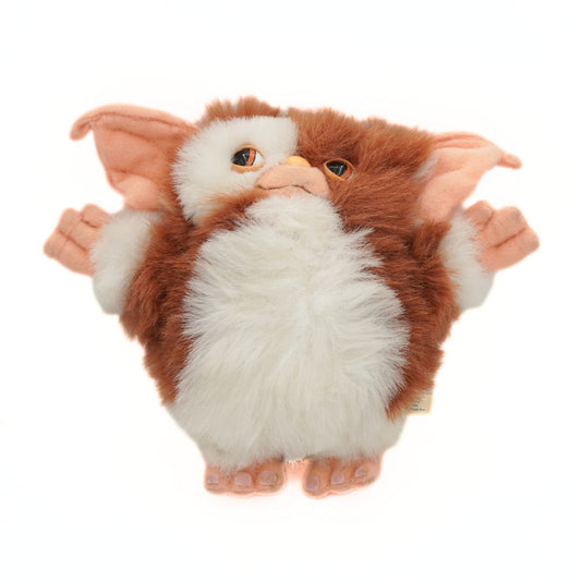 Plush toy resembling a creature with large ears and white fur on a white background