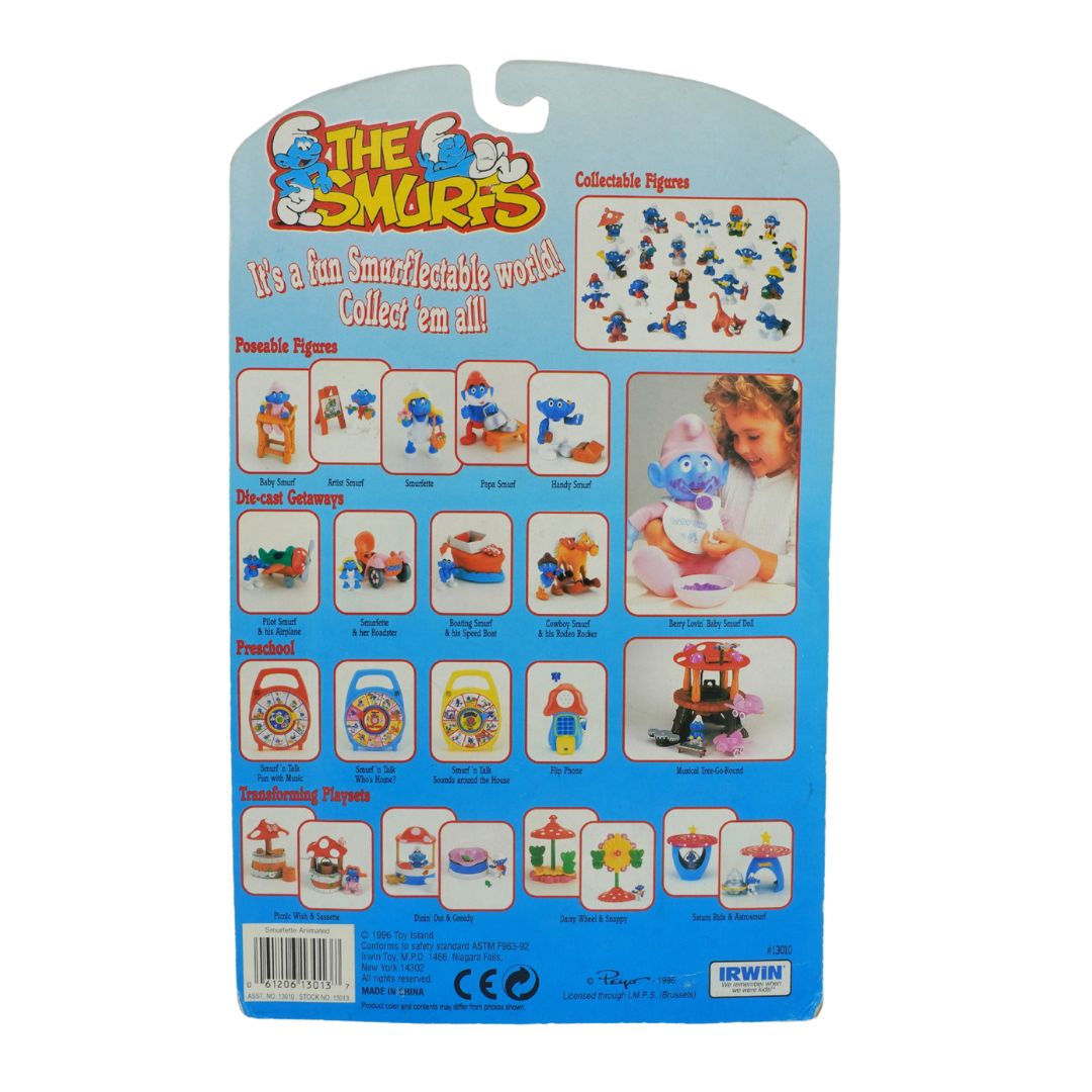 Packaging of The Smurfs collectible figures with images of Smurfs and a child.