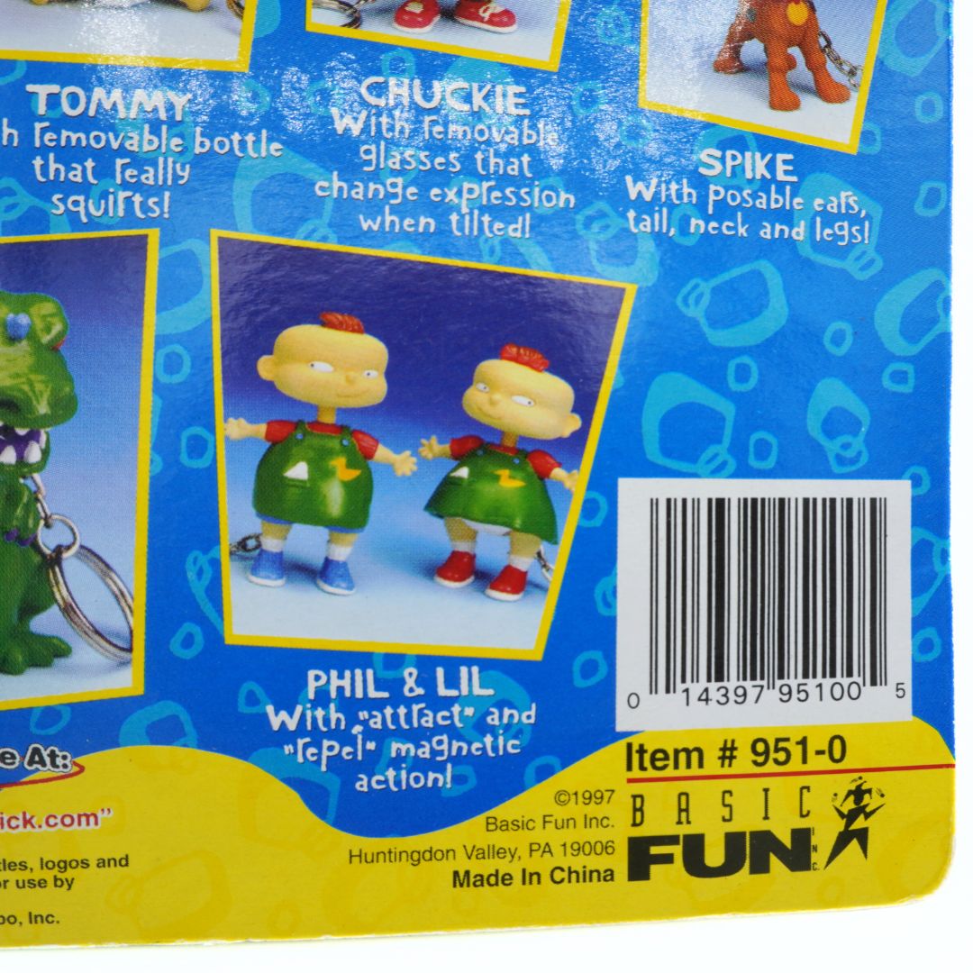 Back of a toy packaging featuring Tommy, Chuckie, Spike, Phil, and Lil with product details and Basic Fun branding.