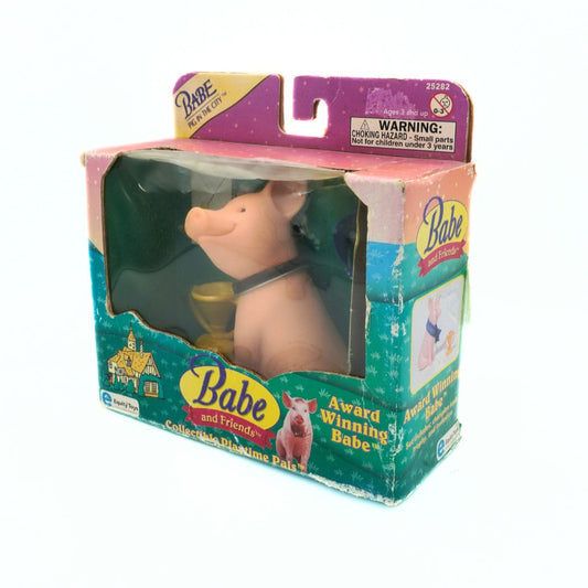 Toy figure of Babe in packaging with visible warning label