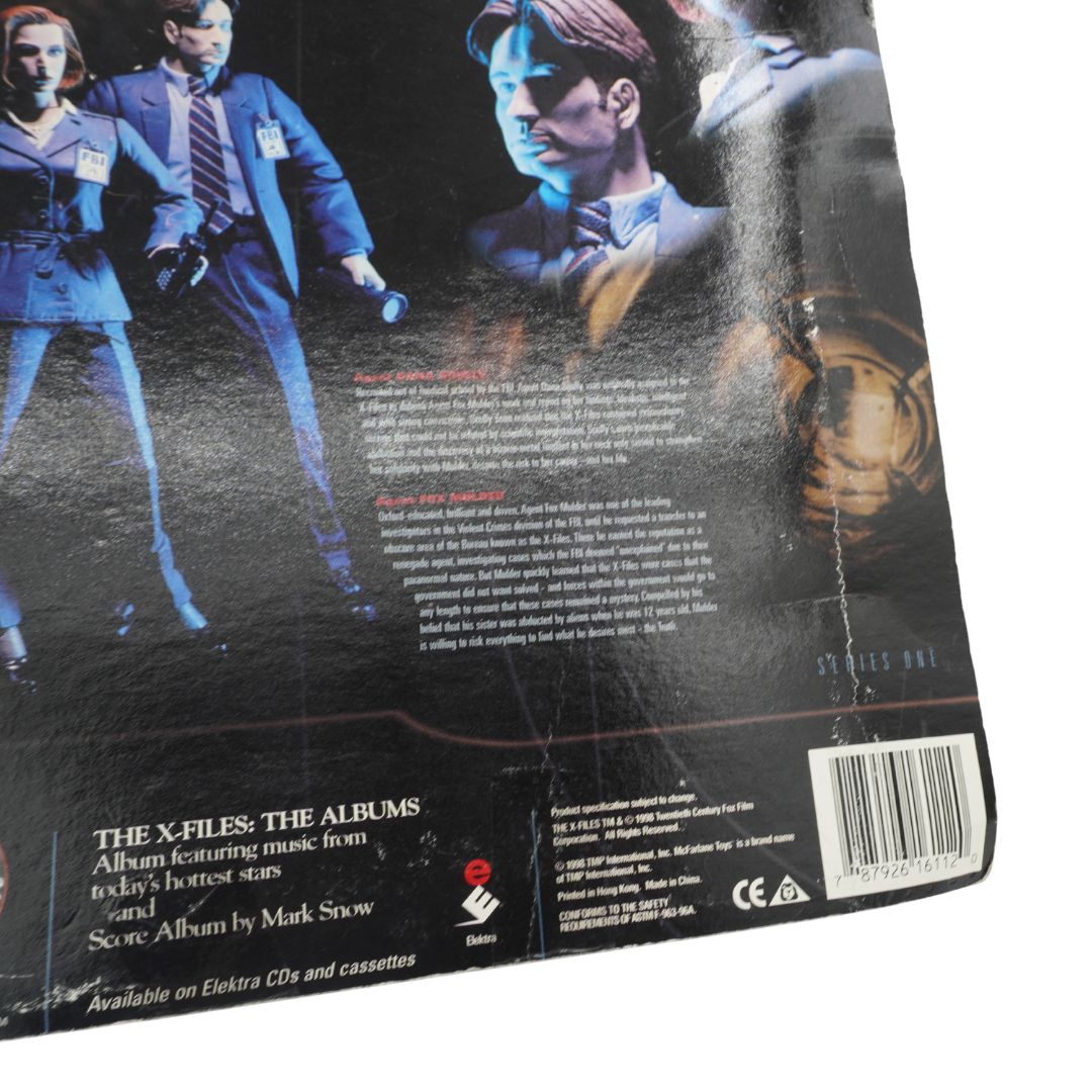 Back cover of a toy featuring characters from 'The X-Files' with text and branding.