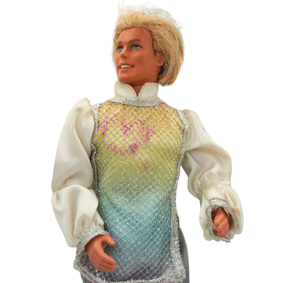 Toy doll with a colorful dress on a white background