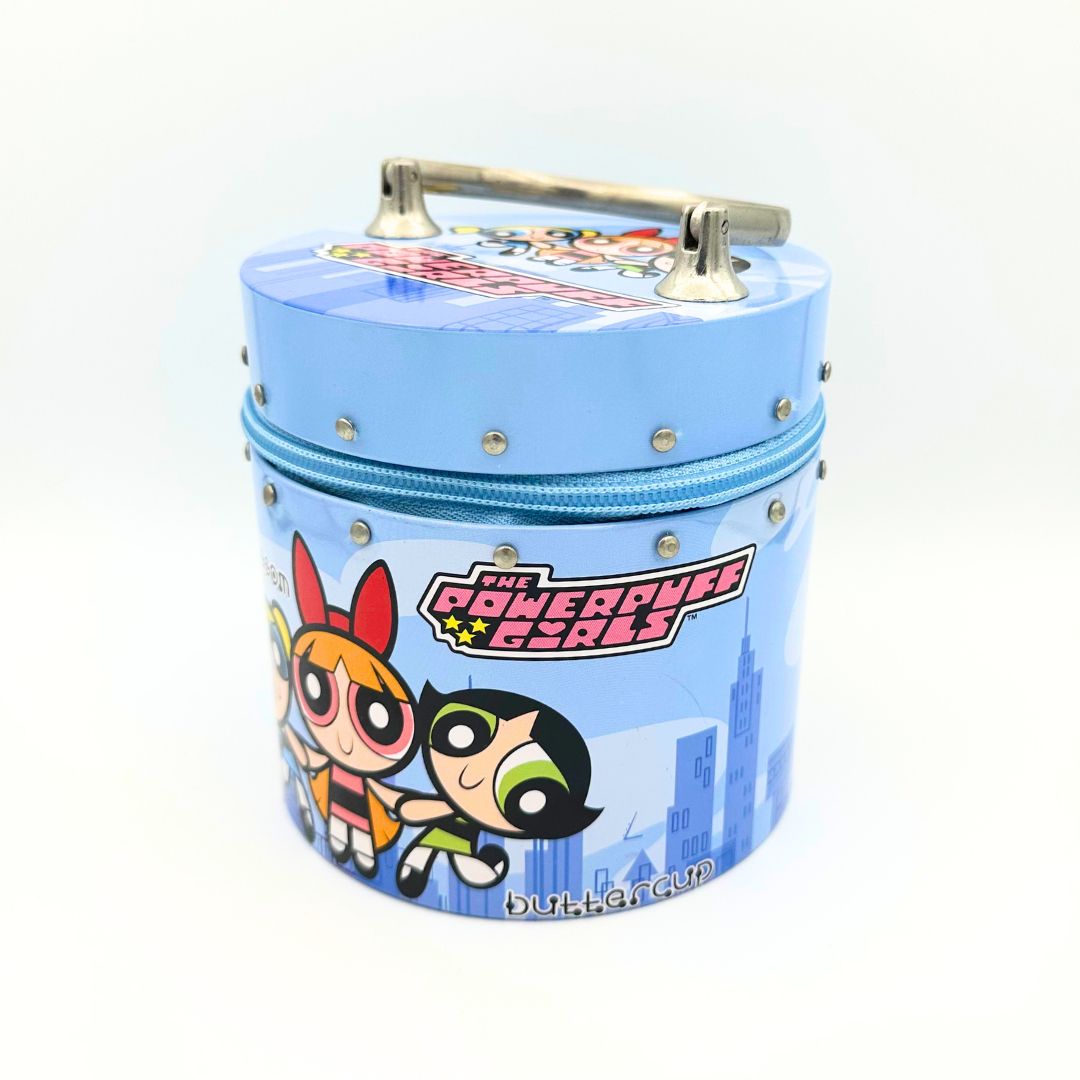 Blue tin bag with a silver metal handle featuring Powerpuff Girls characters in front of a skyline