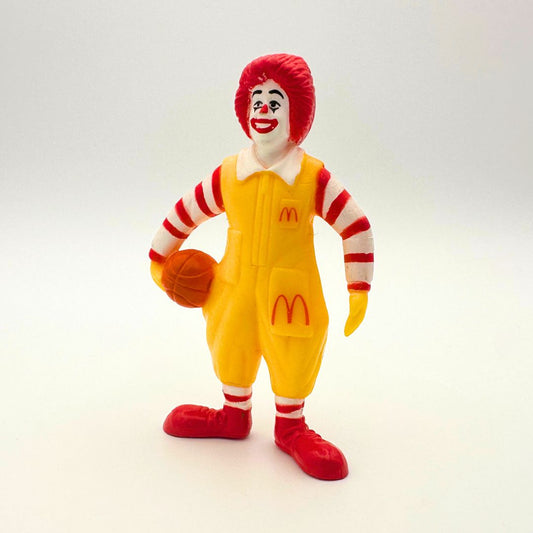 Vintage Ronald McDonald figure holding basketball