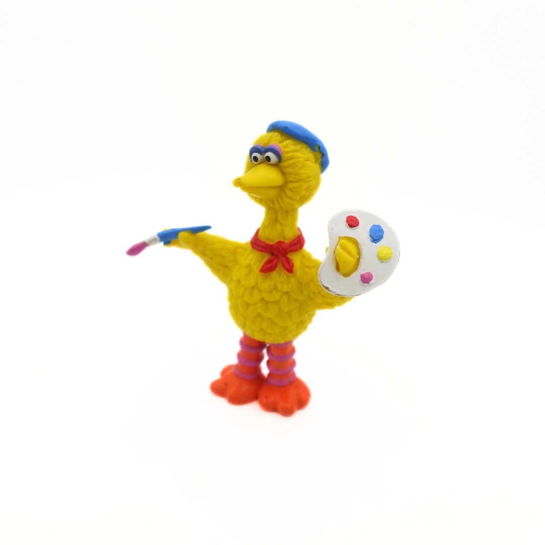 A Big Bird figure dressed up as a painter