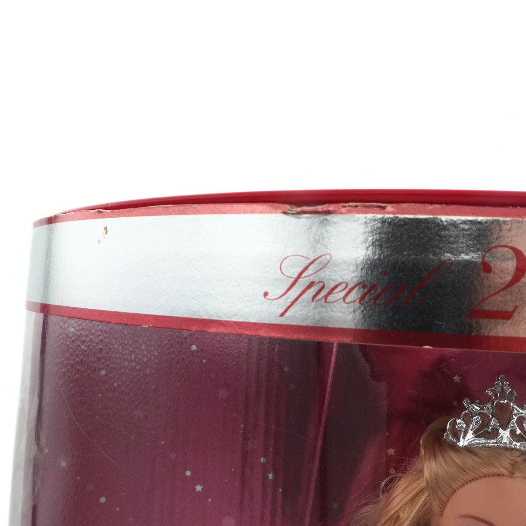 Close-up of a red gift box with 'Special 2' text and a doll wearing a tiara.