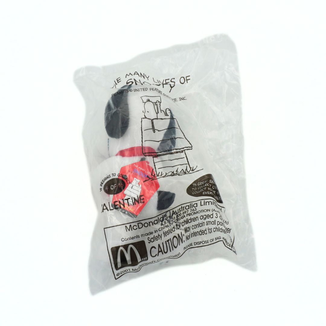 Small plush toy with packaging featuring a cartoon character and text on a white background