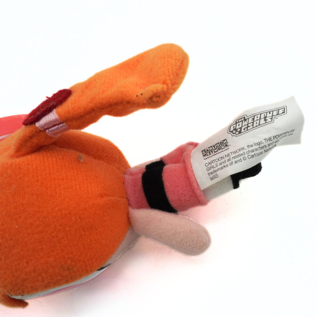 Orange plush toy with a label on a white background