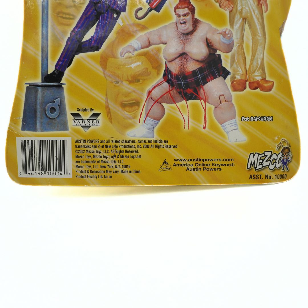 Back of a toy figure packaging with character illustration and branding details.
