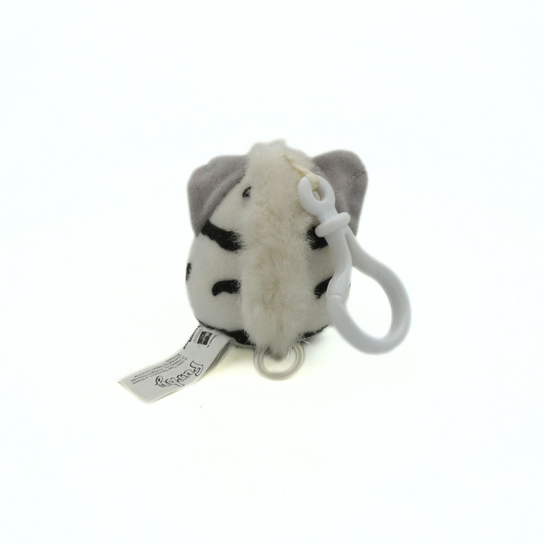 Plush dog toy with a tag on a white background