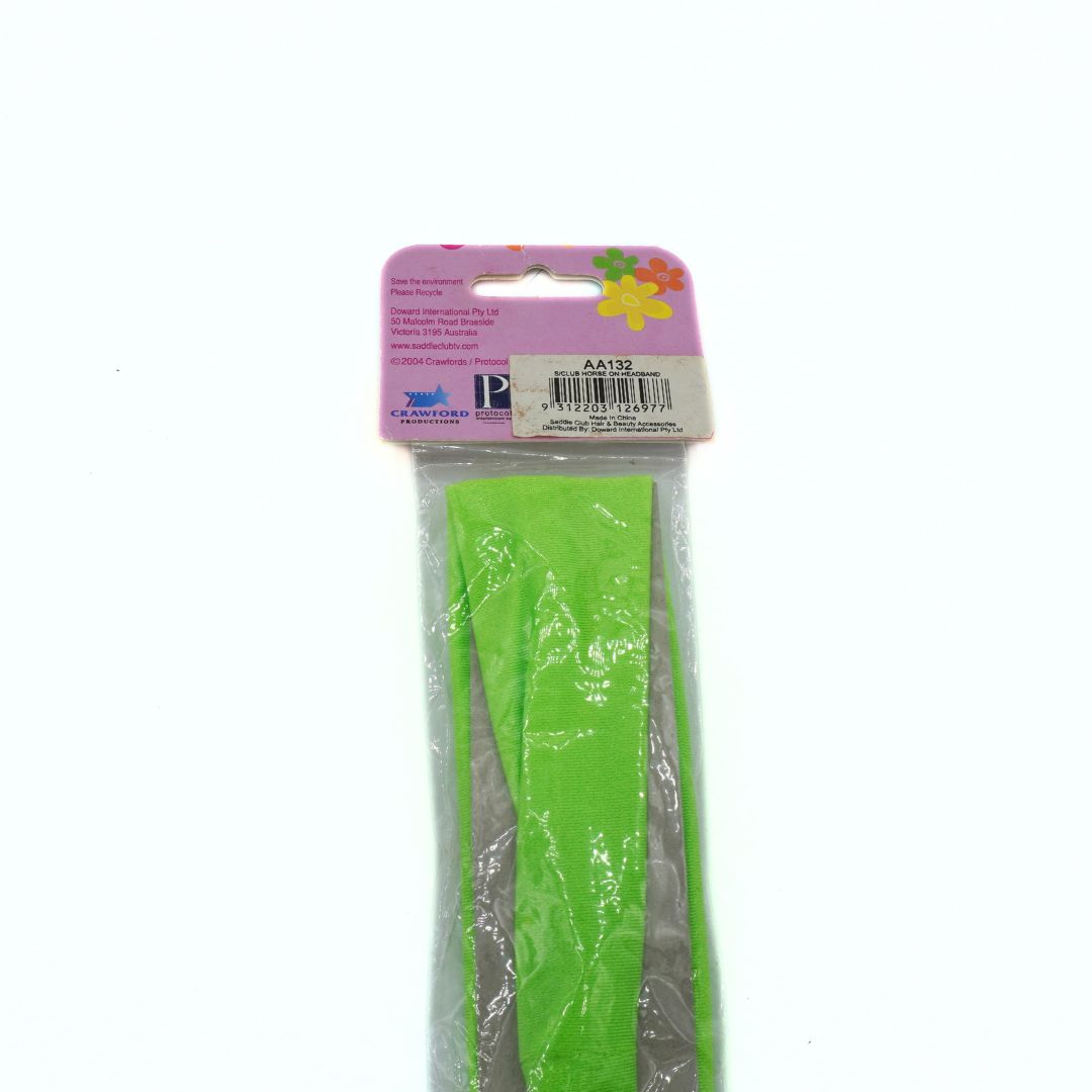 Green headband in clear packaging with a pink label on a white background