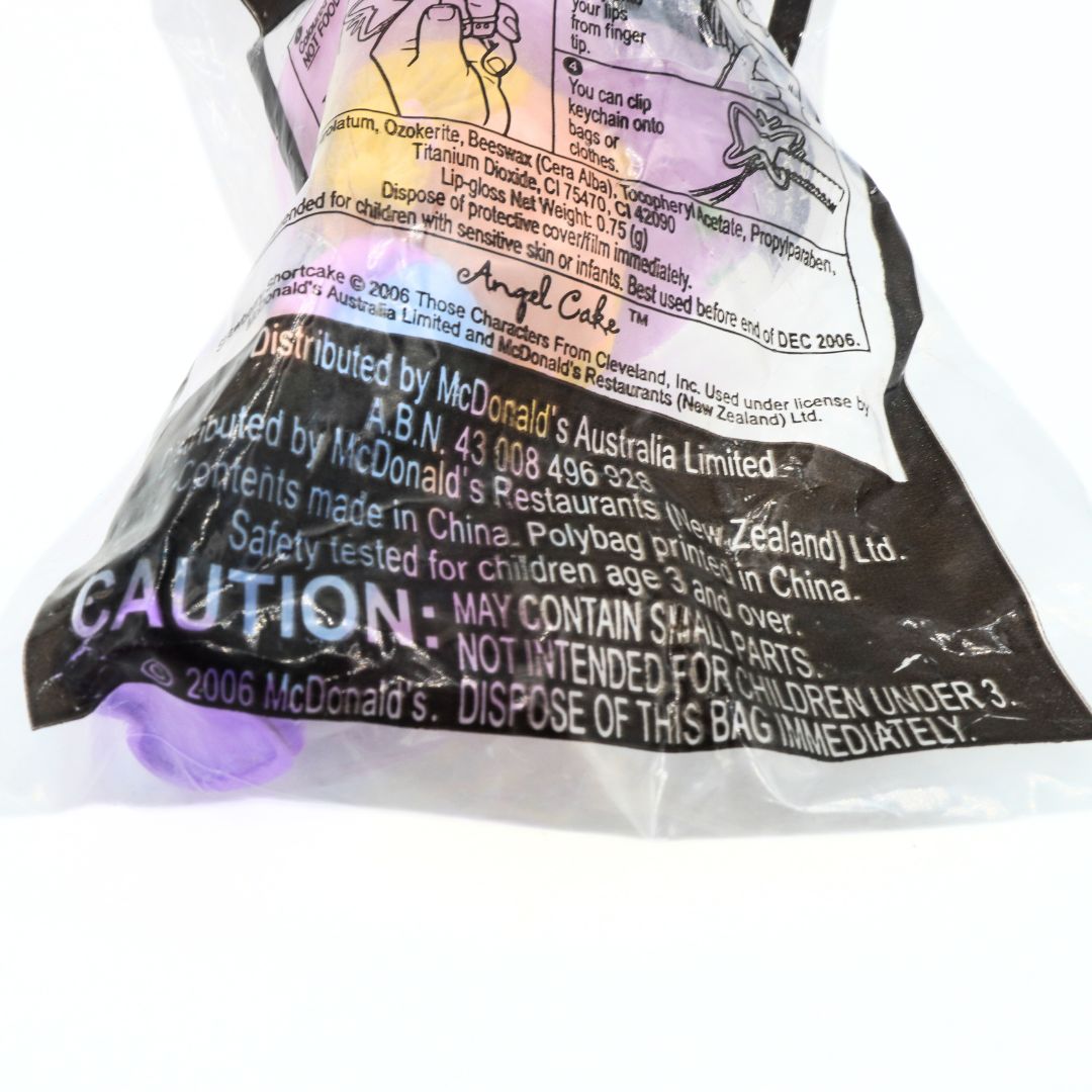 Close-up of a McDonald's toy packaging with warning labels and text.