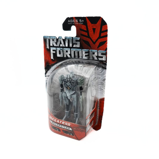 Photo of a grey Hasbro Megatron Transformers figurine inside a red and black packaging