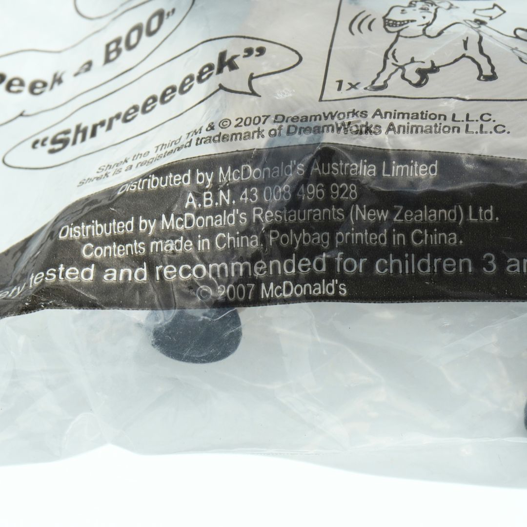 Close-up of a McDonald's toy packaging with branding and text.