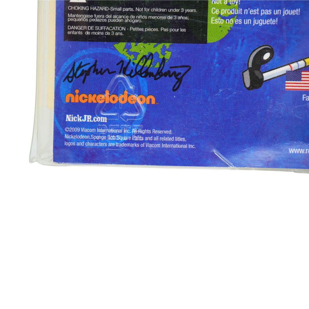 A close-up of a blue collectible autographed Nickelodeon product packaging or card featuring a signature in black marker, the Nickelodeon logo in orange, and a small graphic of a toy on a white background.