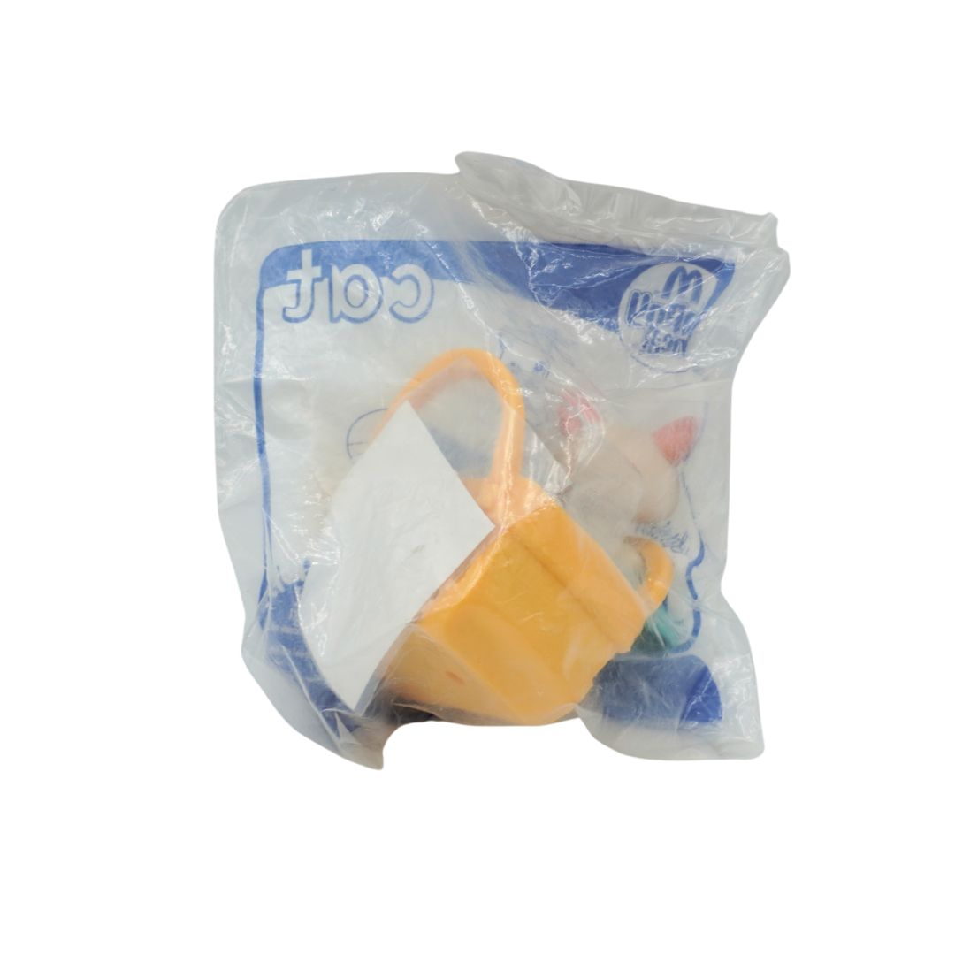 Toy figure in a plastic bag with McDonald's branding on a white background