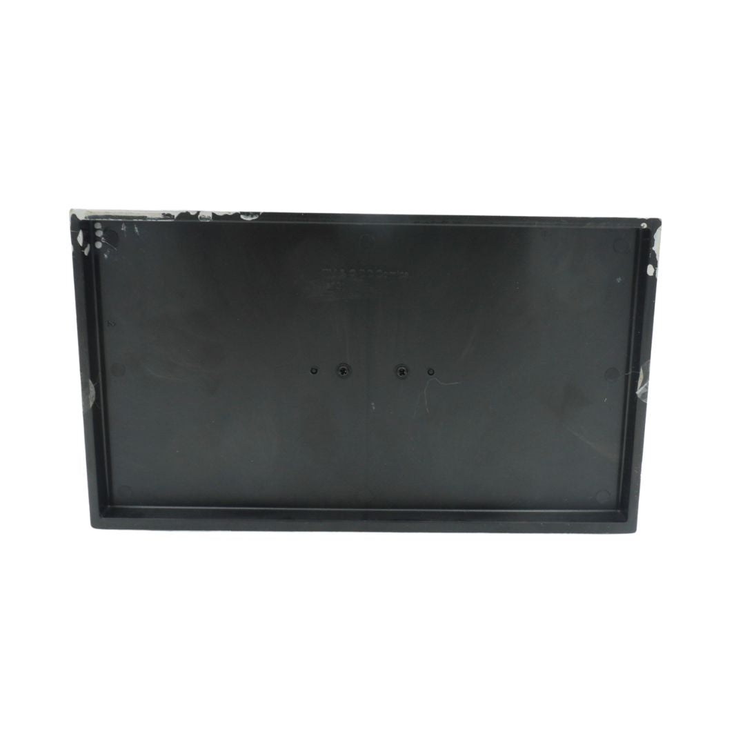 Black rectangular object with visible wear on a white background
