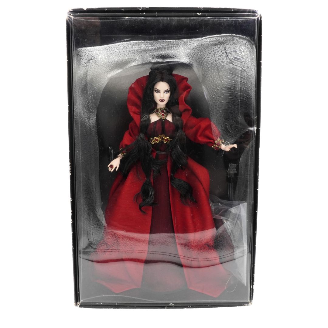 Barbie doll in a red dress with black accents in clear packaging