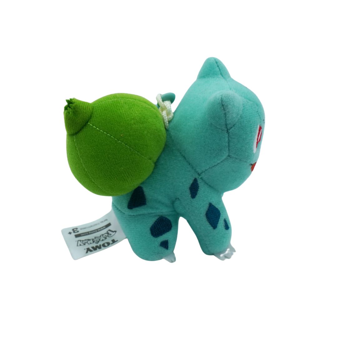 Plush toy with green head and blue body on a white background