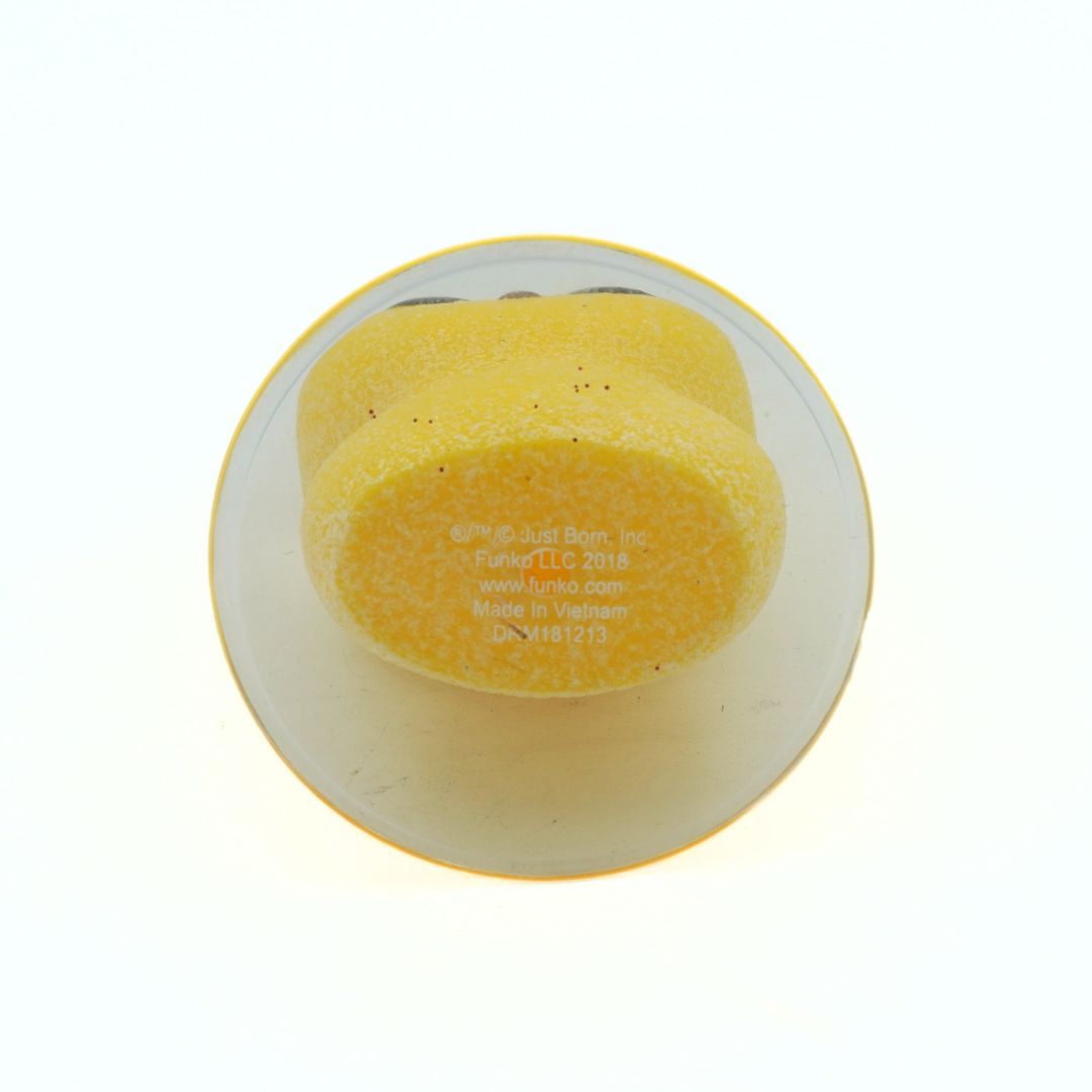 Yellow Funko on a clear plate with visible branding