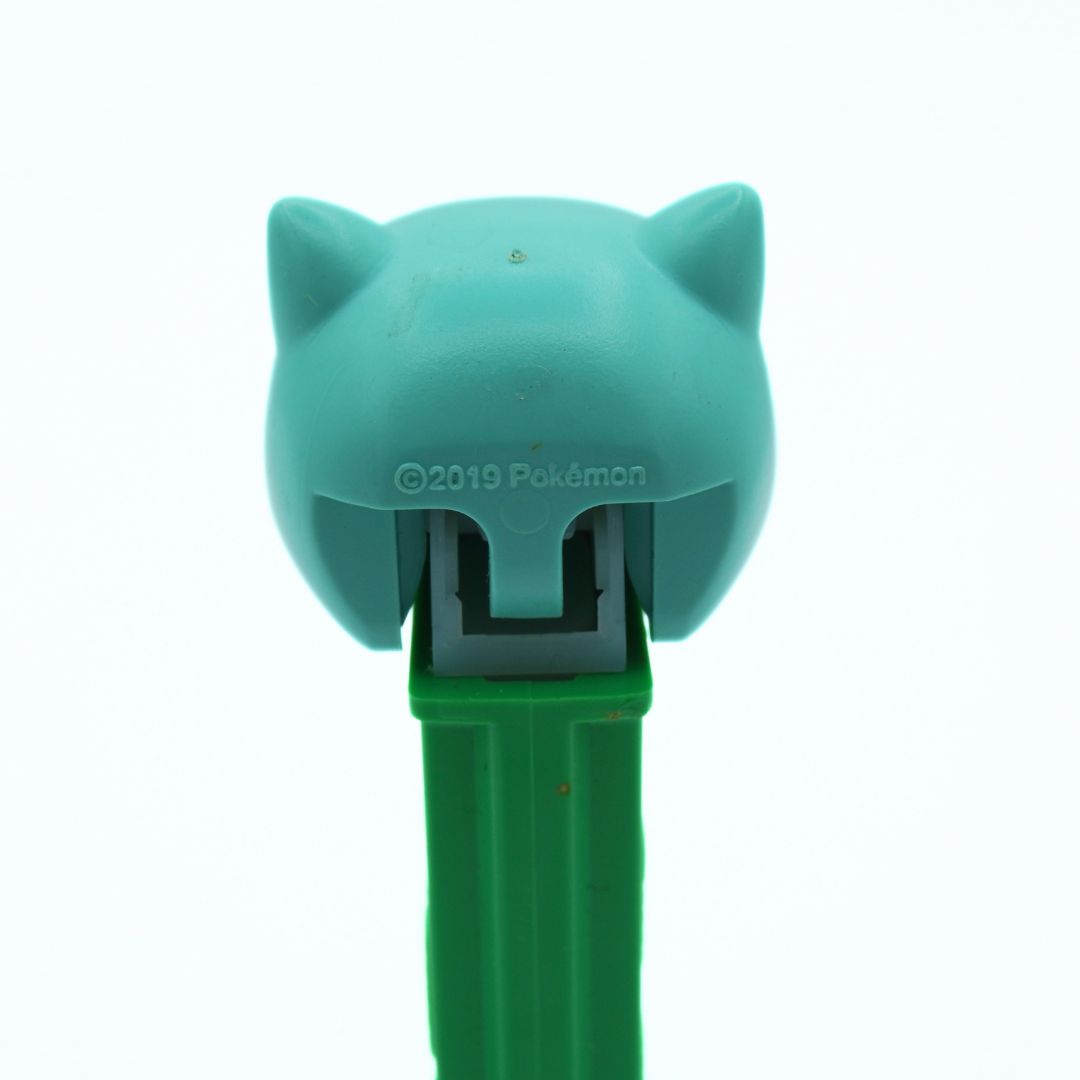 Teal and green character-shaped PEZ with '2019 Pokémon' branding on a white background