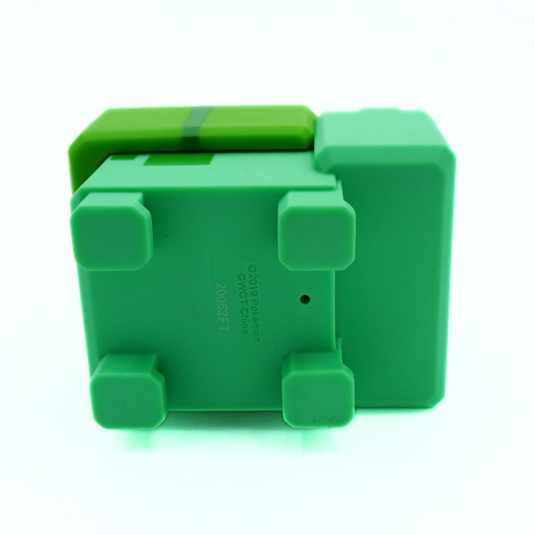 Green plastic component on a white background