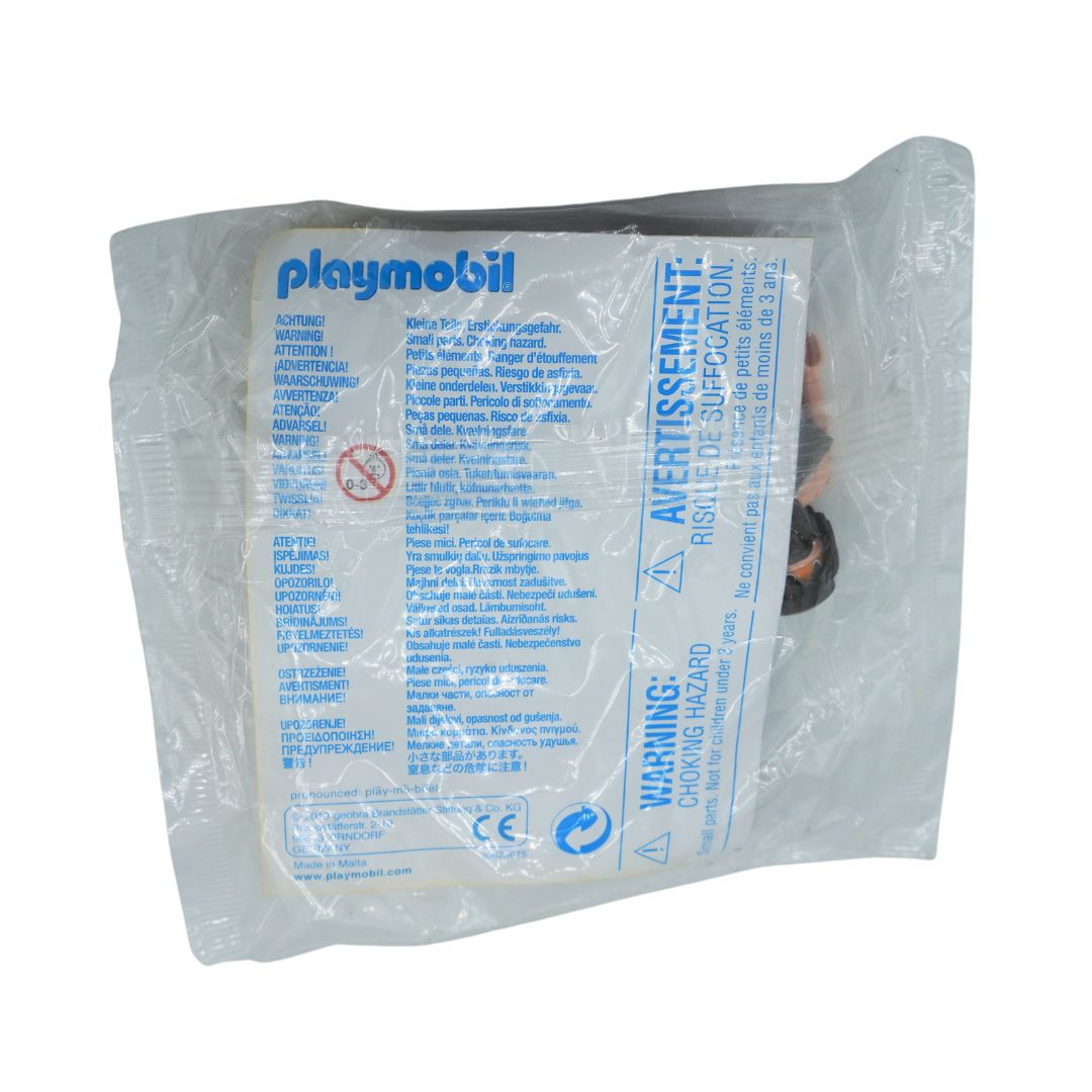 A packaged Playmobil toy figure sealed in a clear plastic bag with a printed white and blue instruction/compatibility card. The Playmobil logo is visible at the top left of the card.