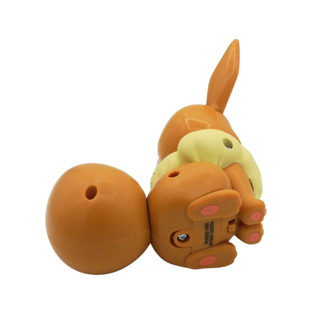 Underside picture of a brown Eevee electronic toy from the series Pokemon, on a white backdrop