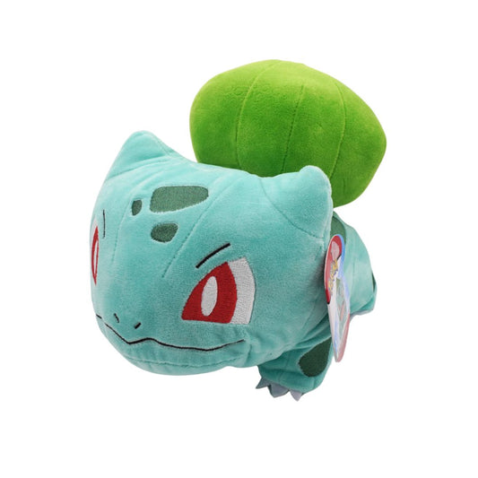 Plush toy of a green and blue creature with a tag on a white background