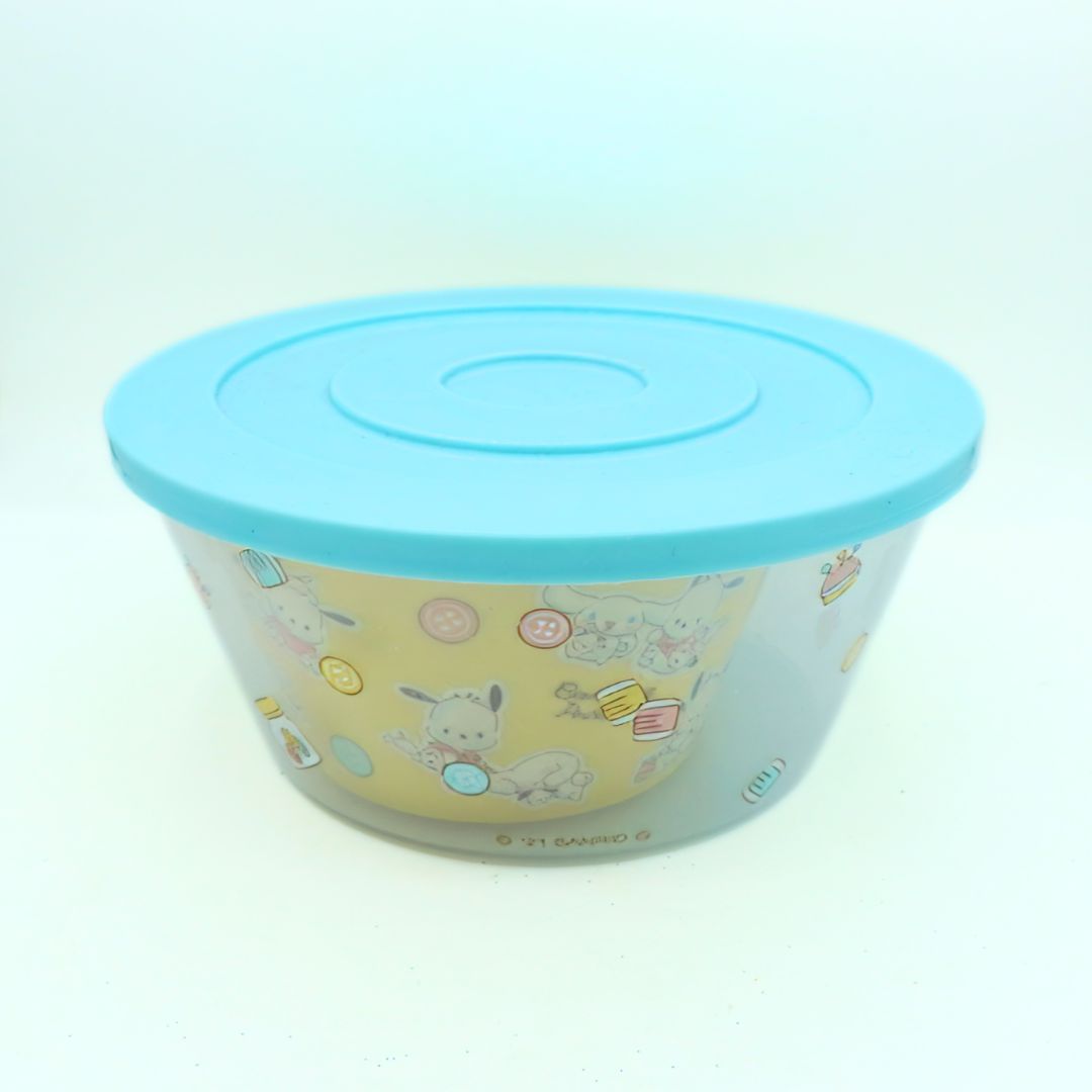 Photo of a blue and yellow bowl featuring Sanrio characters, photographed against a white background